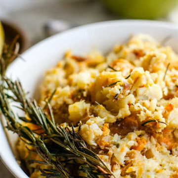 An up-close photo of a bowl of rosemary carrot & parsnip mash.