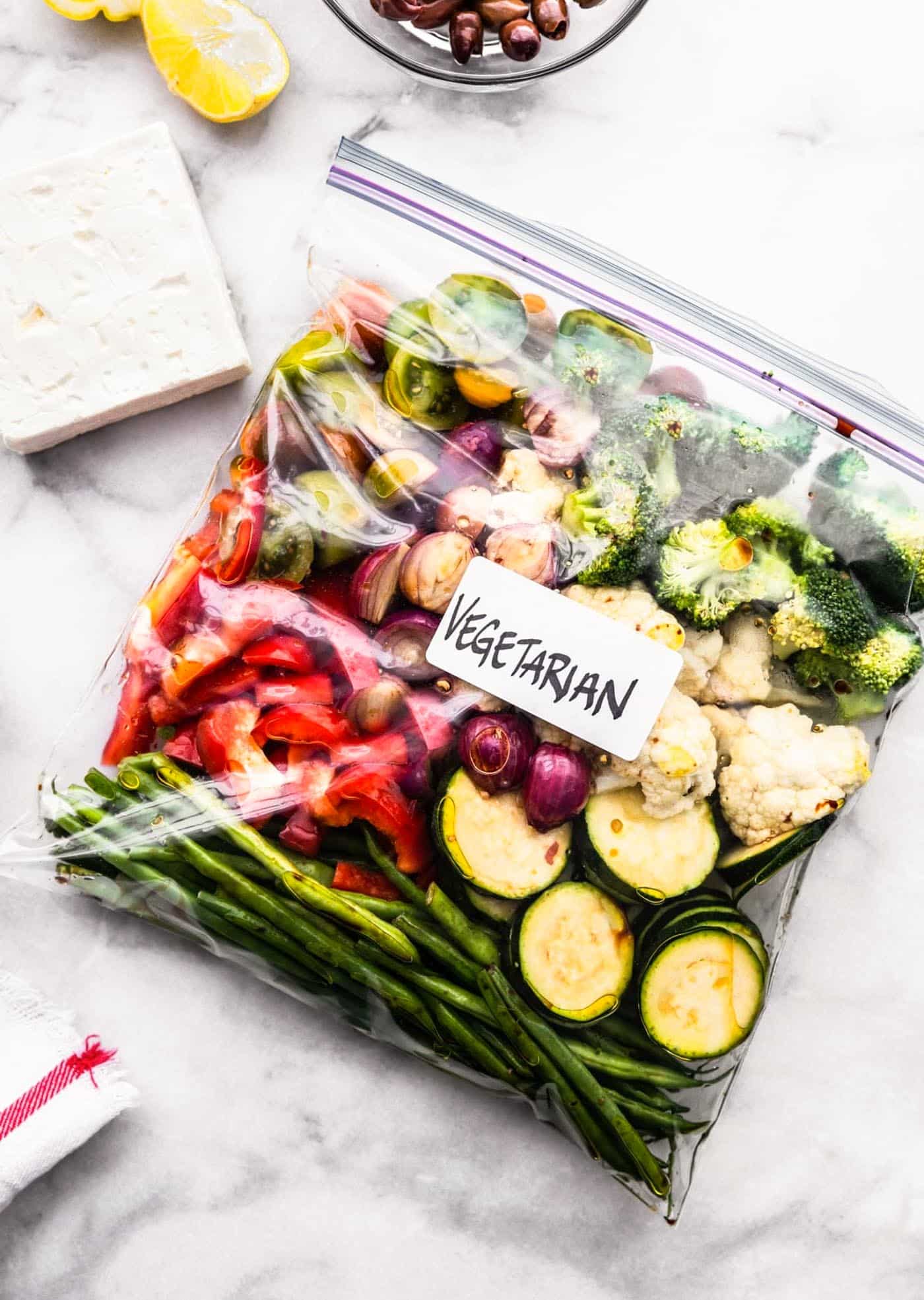 A gallon-sized bag labeled "vegetarian" with Greek marinated vegetables.