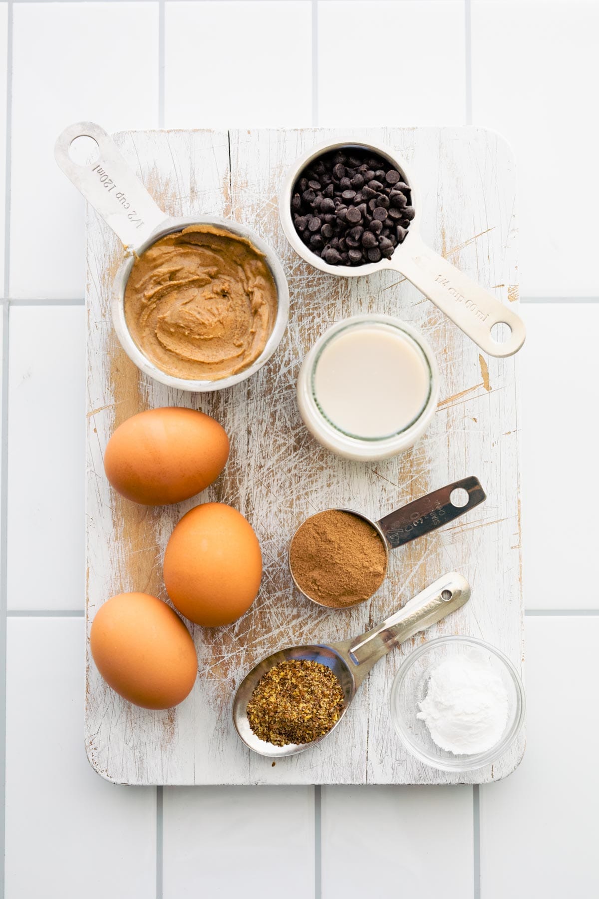 ingredients in measuring cups and bowls to make chocolate protein pancakes