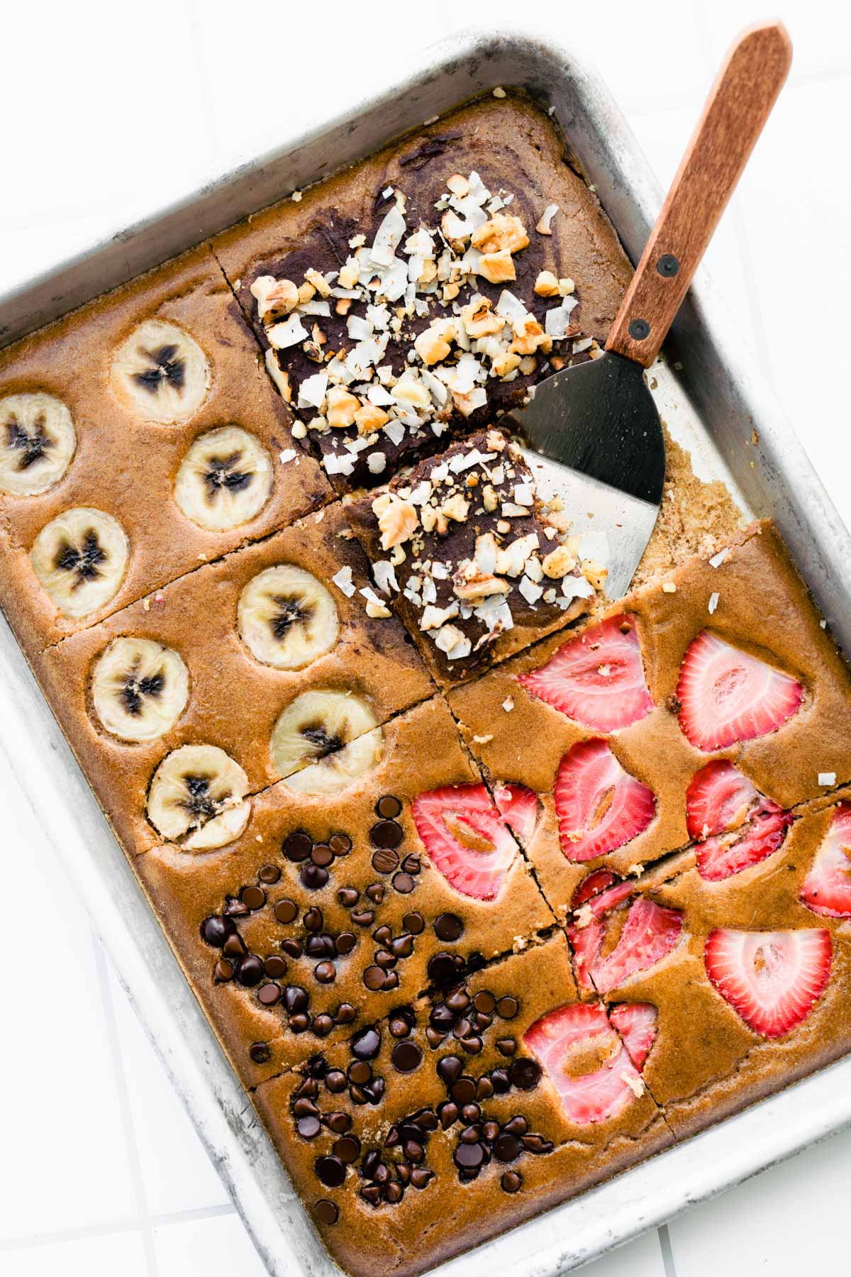 spatula removing slice of keto oven baked pancakes from a sheet pan