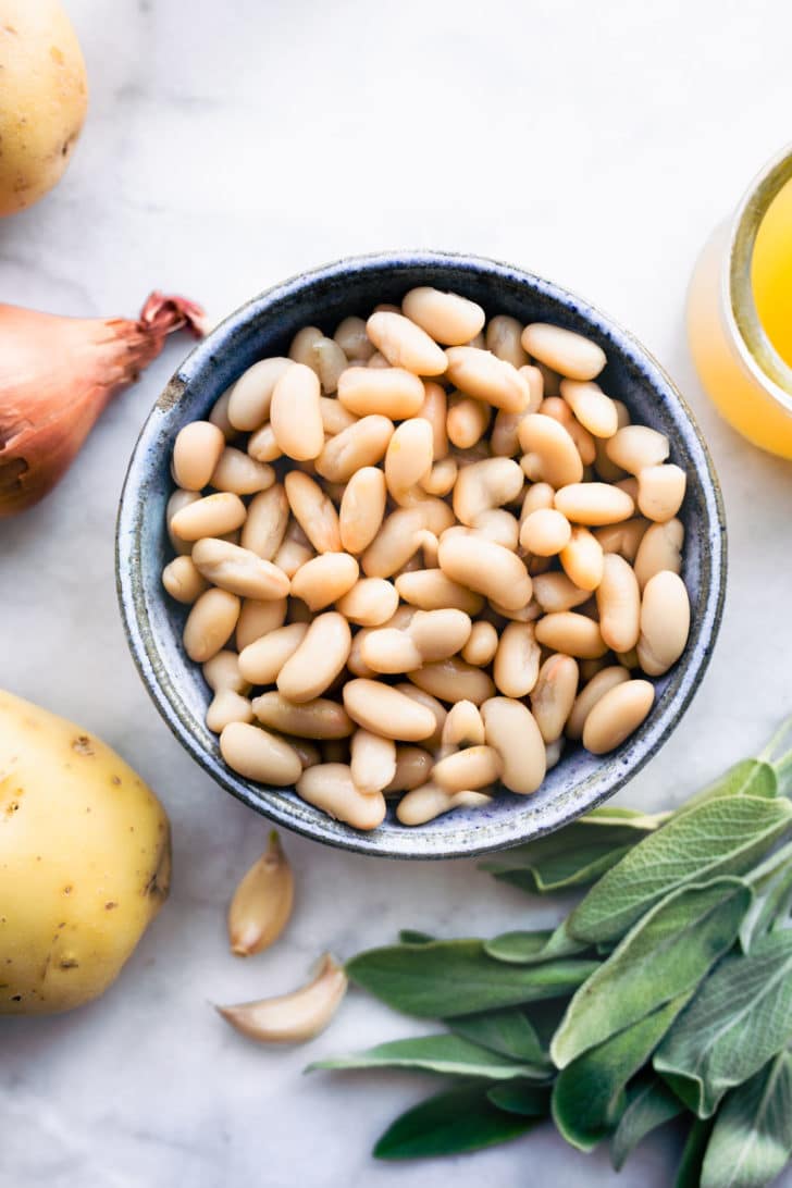 Cannellini beans, potatoes, shallots, broth, and herbs for slow cooker dairy free mashed potatoes