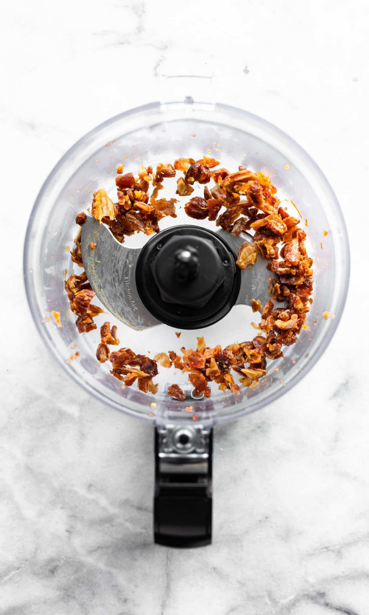 Overhead photo of date pieces in a food processor.