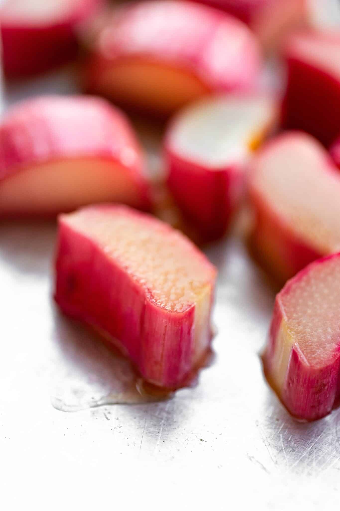 Up close photo of sliced rhubarb on a metal sheet pan.