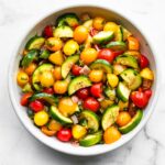 A bowl of three herb tomato zucchini salad.
