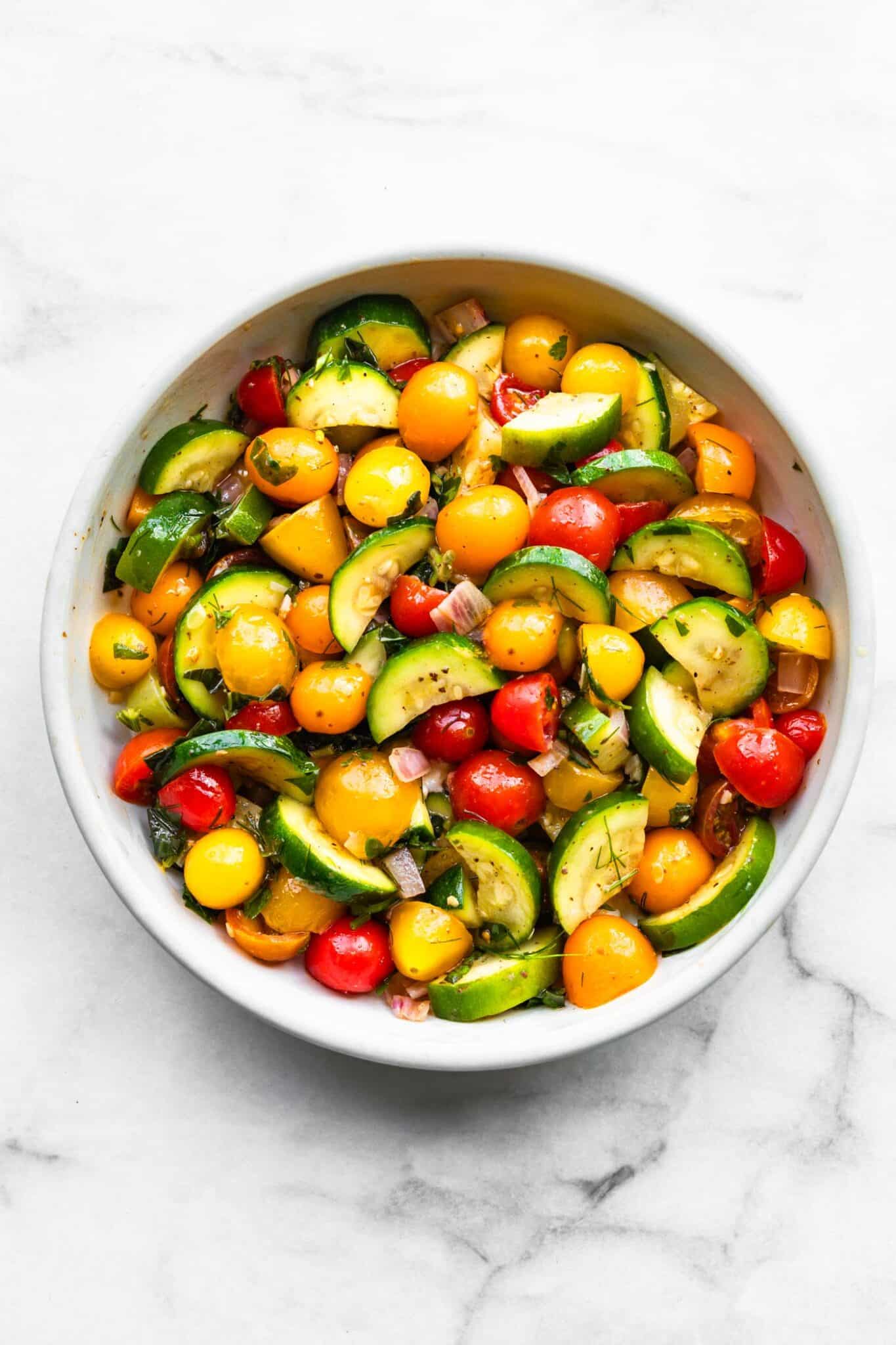 A bowl of three herb tomato zucchini salad.
