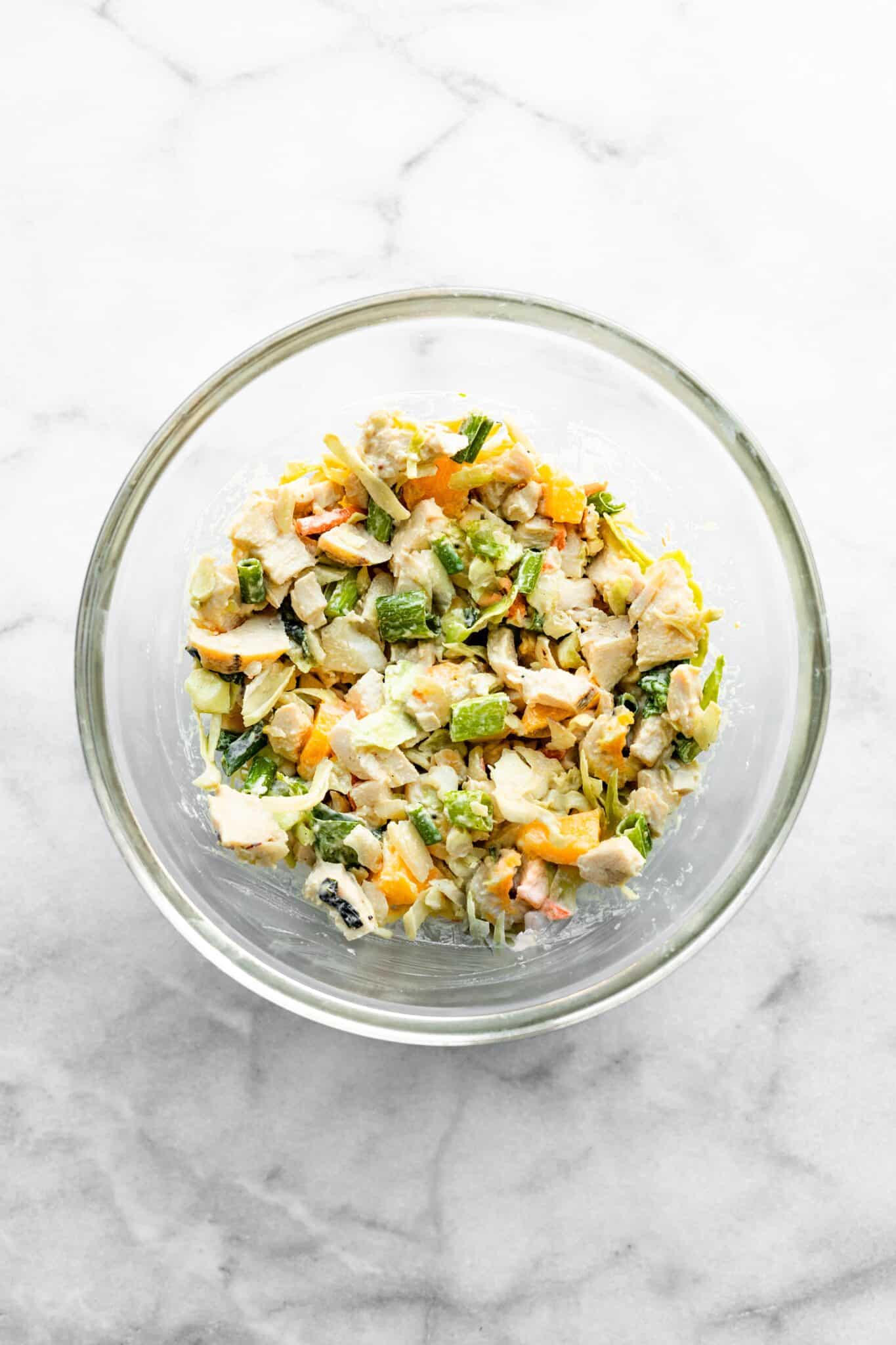 Overhead photo of a glass bowl of Asian chicken salad.