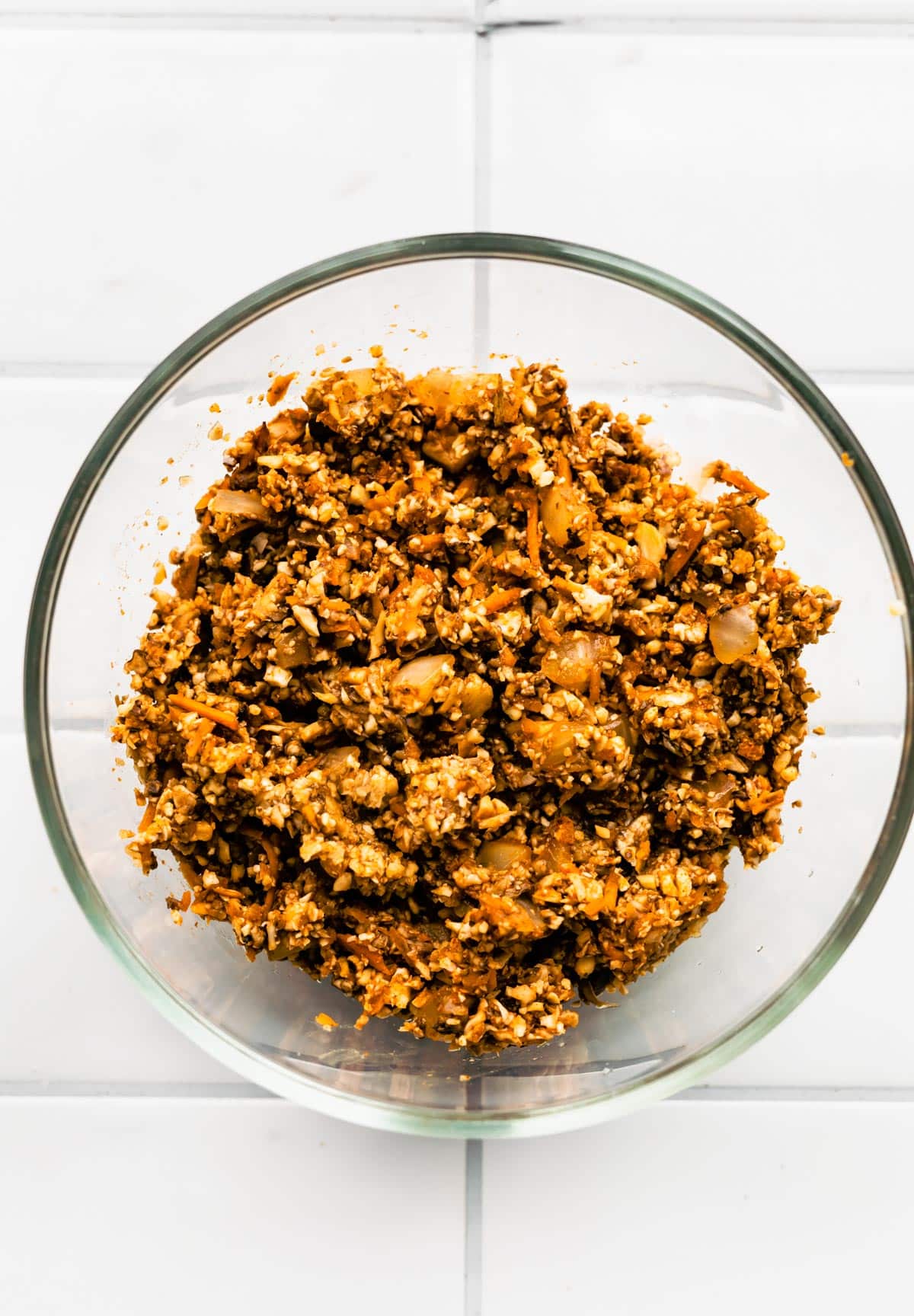 Homemade vegetarian taco meat in a glass bowl on a white countertop.