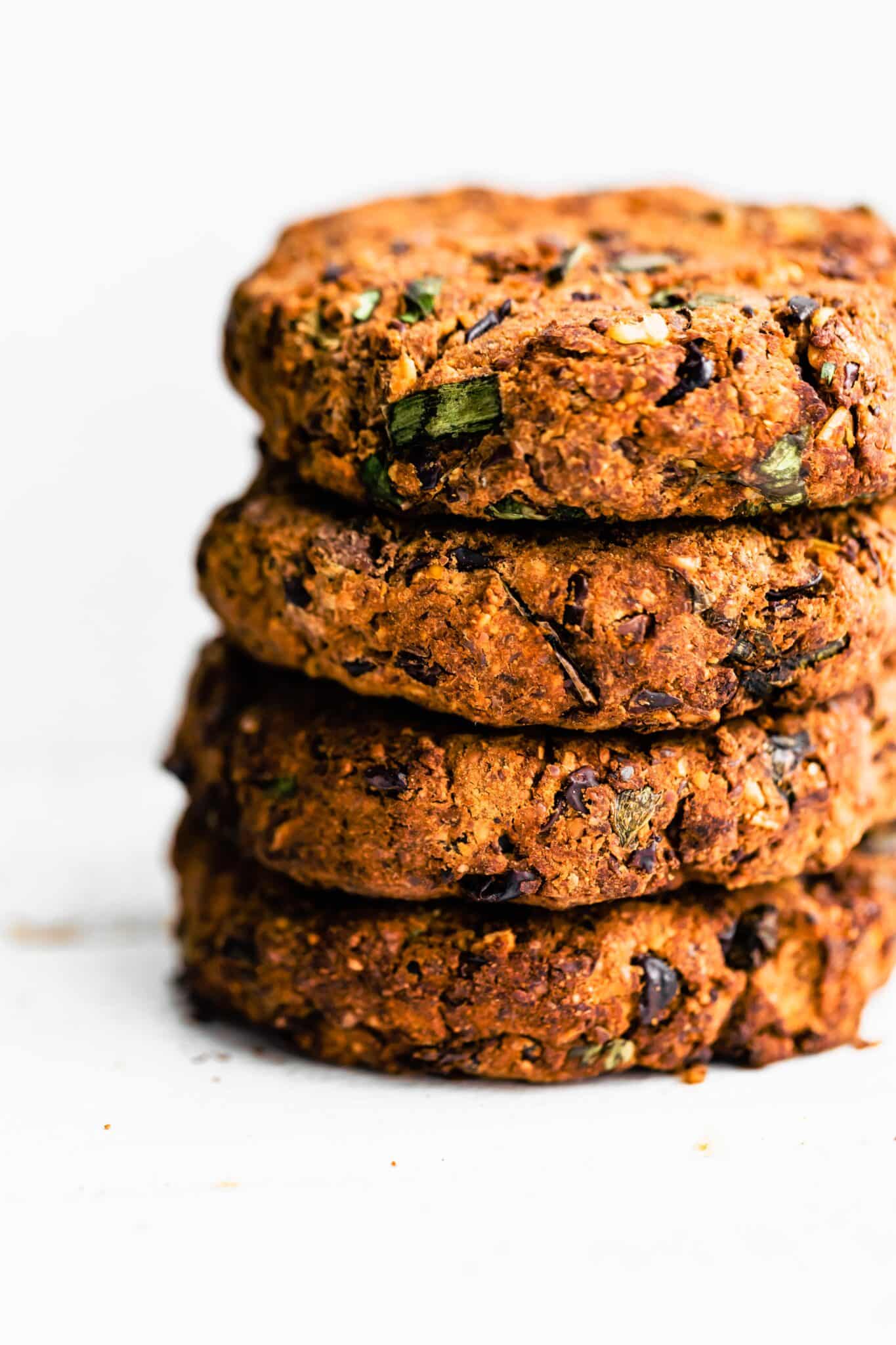 A stack of four air fried black bean burgers.