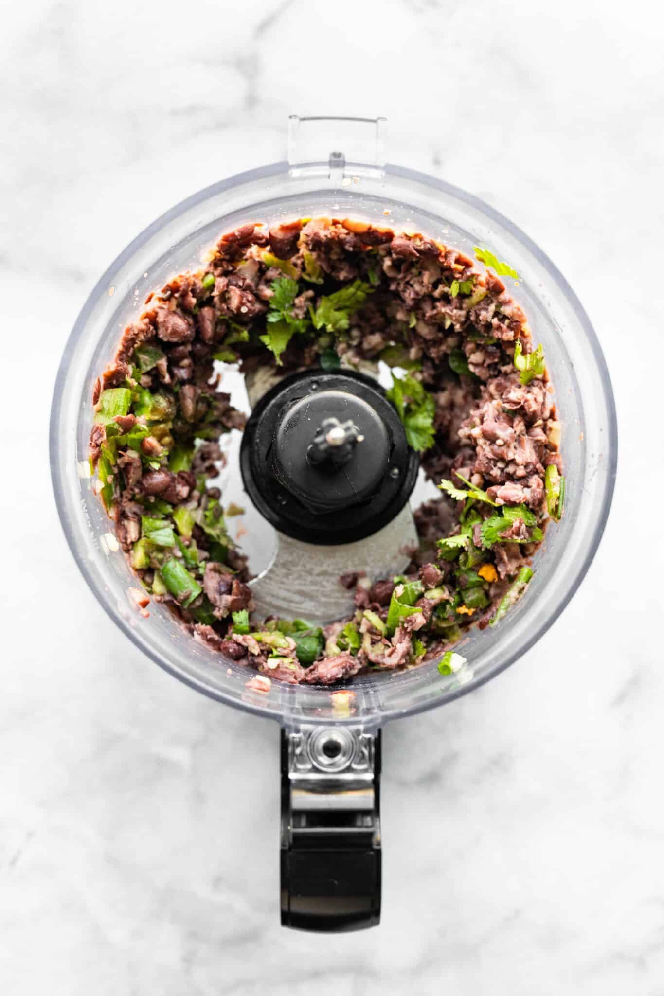 Black beans and sauteed vegetables pulsed a few times in a food processor.
