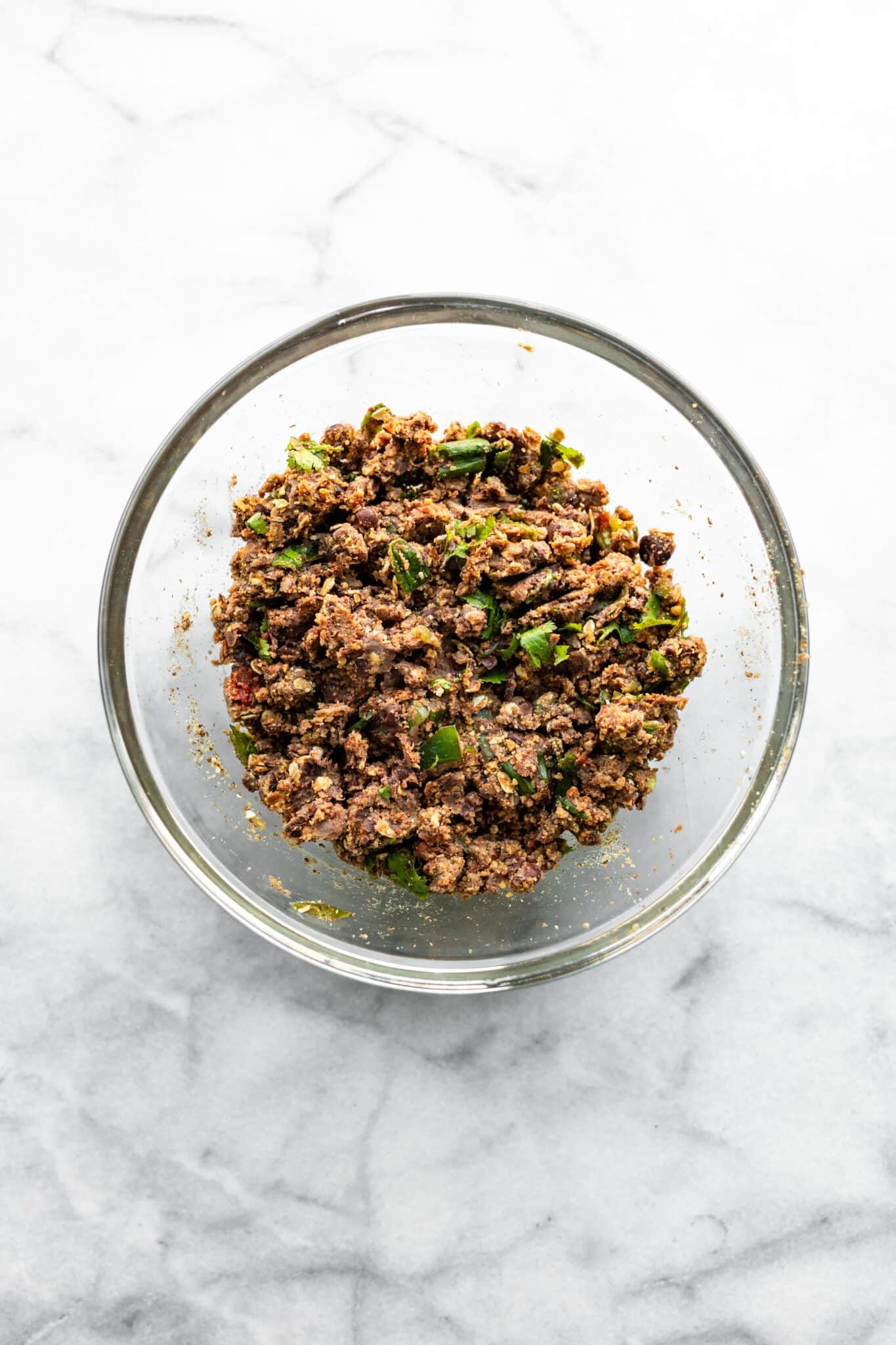 Overhead photo of black bean burger mixture in a glass bowl.