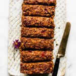 Overhead photo of a glazed vegan lentil loaf with a knife on the side.