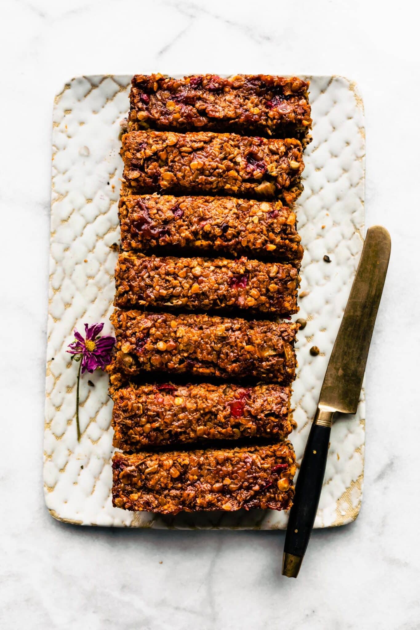 Overhead photo of a glazed vegan lentil loaf with a knife on the side.