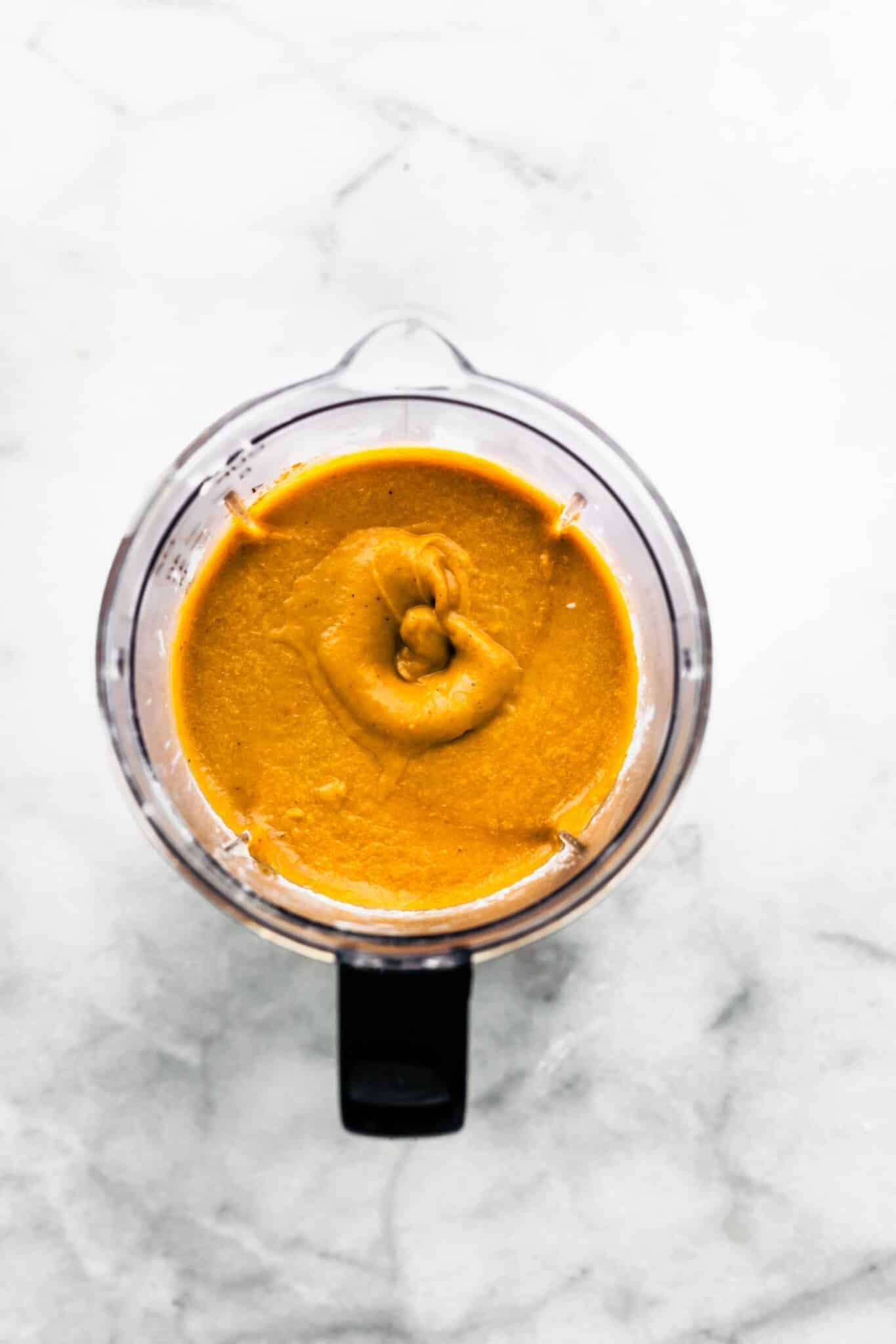 Overhead photo of pumpkin pie filling in a food processor.