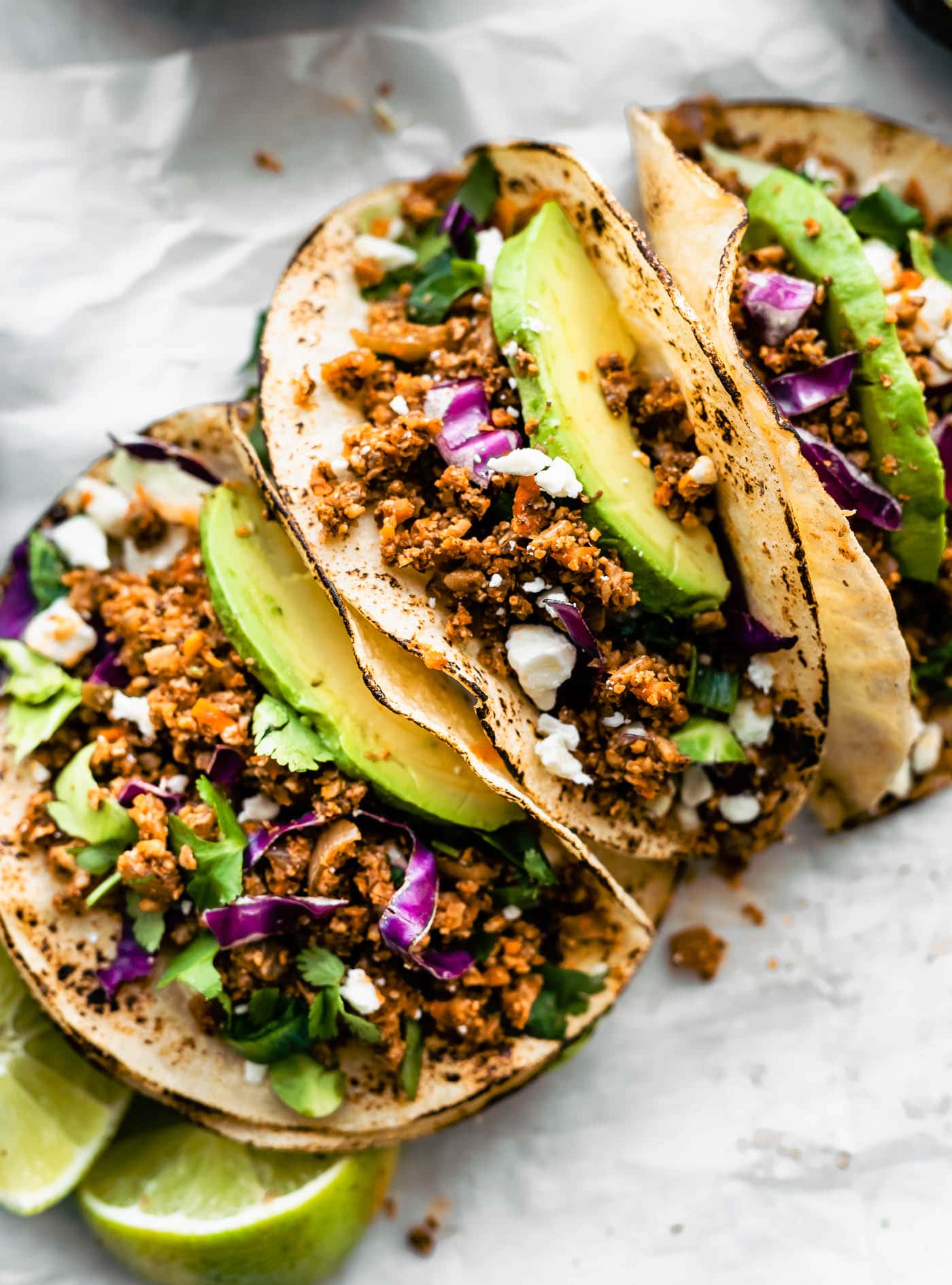 Close up image of tortillas with vegan taco meat served as soft shell tacos.